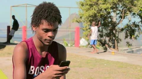 Funky young man text messaging on mobile phone Video stock 61273738