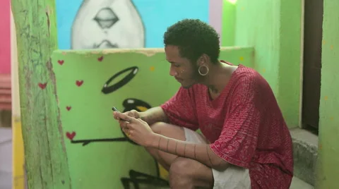 Funky young man typing a message on his mobile phone Video stock 61273647