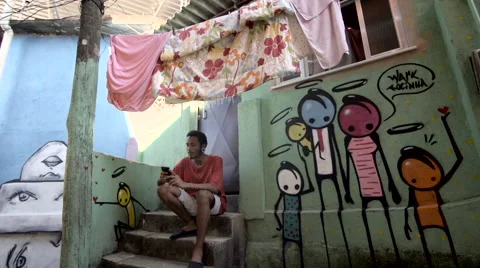 Funky young man typing a message on his mobile phone Stock Footage 61292335