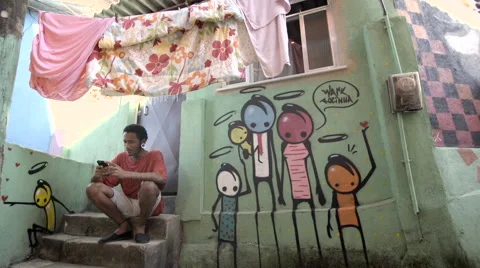 Funky young man typing a message on his mobile phone Stock Footage 61292338