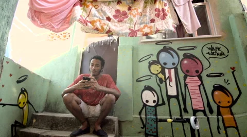 Funky young man typing a message on his mobile phone Stock Footage 61292348