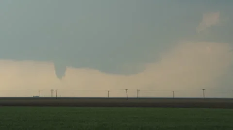 Funnel cloud about to become a tornado at the base of a wall cloud over Stock Footage 59513838