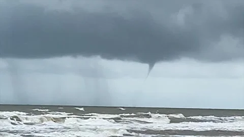 Funnel Cloud Developing Over Choppy Ocean Waves and Dark Stormy Sky Stock Footage 321379504