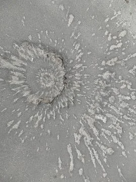 Funnel on the pavement from the explosion of a shell. Traces of the war on .. Stock Photos