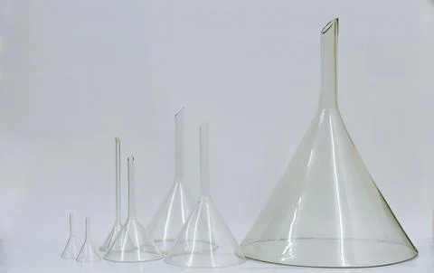 Funnels ,Different size of pharmaceutical funnels, large and small in row. Stock Photos