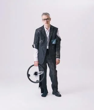 Funny Accident Concept With Man In Torn Suit Holding Steering Wheel 库存照片