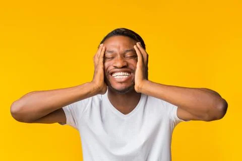 Funny Afro Man Laughing Clutching Head Over Yellow Studio Background Stock Photos