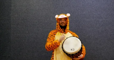 Funny and attractive worker in open space wearing kigurumi, tiger pajama Stock Footage 106079436