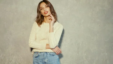 Funny and cheerful model posing near gray wall in studio Stock-Footage 146119266