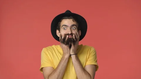 Funny and goofy middle-eastern bearded jewish guy in black hat, yellow t-shirt Stock-Footage 115780072