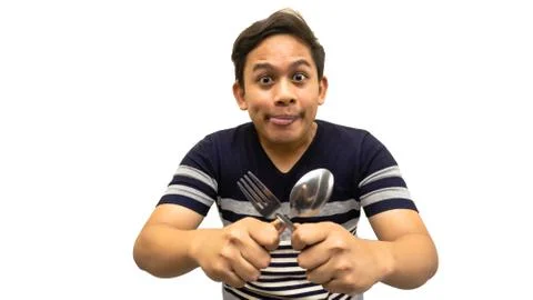 Funny and hungry face expression of young Asian Malay man Stock Photos