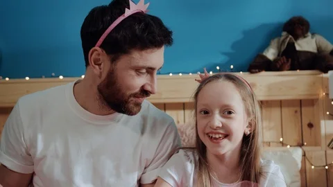 Funny and silly daddy and daughter playing fairies throwing pop corn into focus Stock Footage 112291002