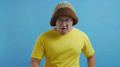 Funny angry Asian man pointing forward giving warn Stock Footage 141609183
