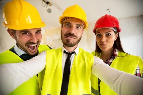 Funny architects workers taking selfie at contruction site Stock Photos