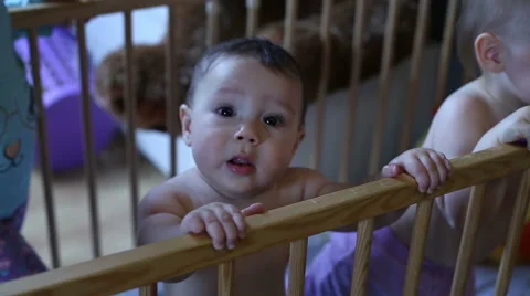 Funny babies playing in cot Stock Footage 62466680