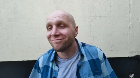 Funny bald man dancing on background of light wall of building. Dancing outdoors Stockbeeldmateriaal 202610436