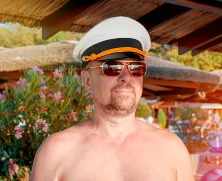 Funny bearded solid captain on the territory of a luxury resort. Stock Photos