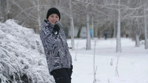 Funny boy dancing and doing yes movement actively in a snowy park in winter Stock-Footage 124522281