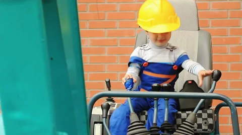 Funny boy as a excavator operator controls the levers Видео 27699665