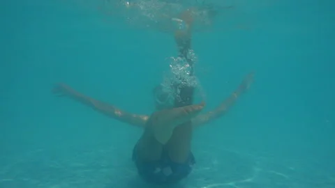 Funny boy with goggles underwater making bubbles and holding breath, close u Vidéo 158731385