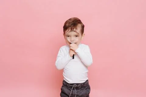 Funny boy looking through magnifying glass with surprise Stock Photos