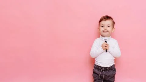 Funny boy looking through magnifying glass with surprise Stock Photos