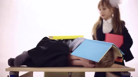 Funny boy lying at school desk Stock Footage 72270229