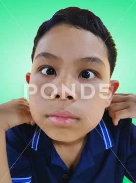 Funny Boy Making Silly Face Isolated on Green Background Stock Photos