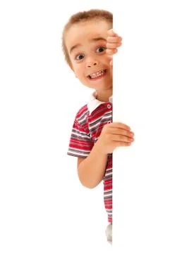 Funny boy mime scary expression behind wall Stock Photos