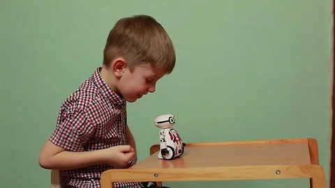 Funny boy playing with an interactive toy robot. Stock Footage 125183641