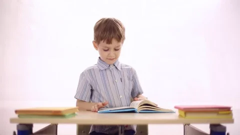 Funny boy sitting at school desk Stock Footage 72269273