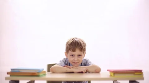 Funny boy sitting at school desk Stock Footage 72269492