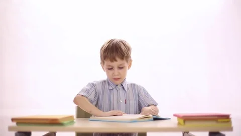 Funny boy sitting at school desk Video stock 72269741