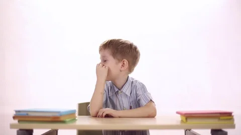 Funny boy sitting at school desk Stock Footage 72270063