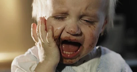 The funny boy smears his face in chocolate. Stock Footage 85828360