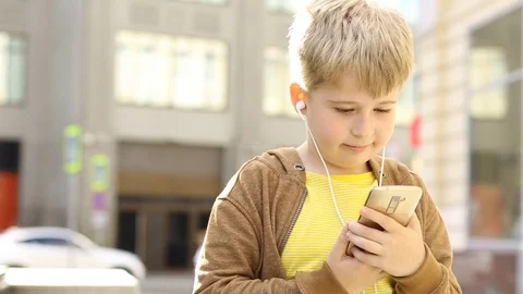 Funny boy using Mobile Phone During Walk on Streets. Stock Footage 77845432