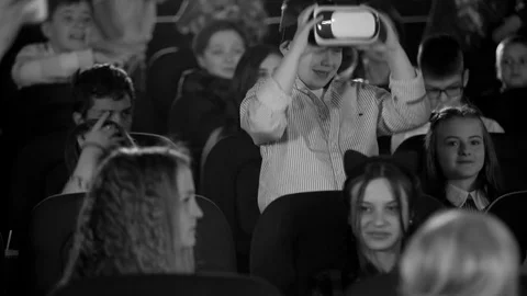 Funny boy in virtual reality glasses, flash phone. Children sitting in the Stock Footage 76002455