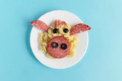 Funny Breakfast for children in the form of a bull's face made of pasta, saus Stock Photos