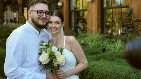 Funny Bride and Groom posing for photographer. Wedding photo shoot. Stock Footage 285452373