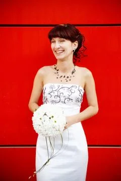 Funny bride by the red wall Stock Photos
