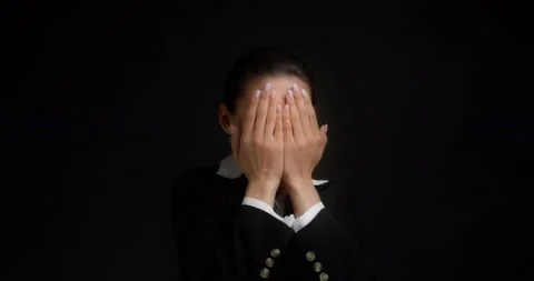 Funny brunette dressed in business clothes is standing on playing hide and seek Stock Footage 192777070