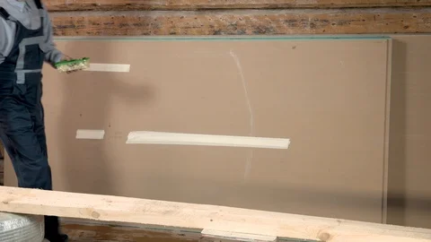 Funny builder is smiling and preparing for dinner. Yummy waiting on a wooden boa Stock Footage 102777096