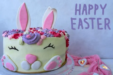 Funny bunny cake for Easter. Text Happy Easter. Greeting card. Modern concept Stock Photos