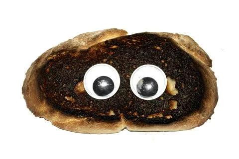 A Funny Burnt Toast Bread Slice Roll With Googly Wobble Eyes Stock Photos