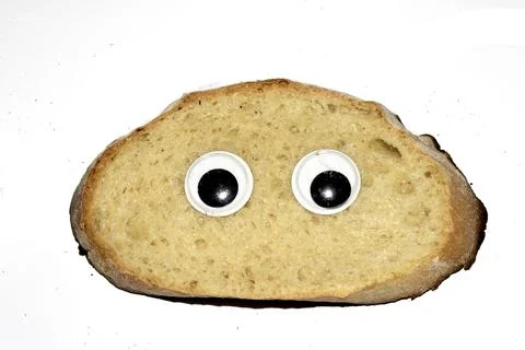 A Funny Burnt Toast Bread Slice Roll With Googly Wobble Eyes Stock Photos