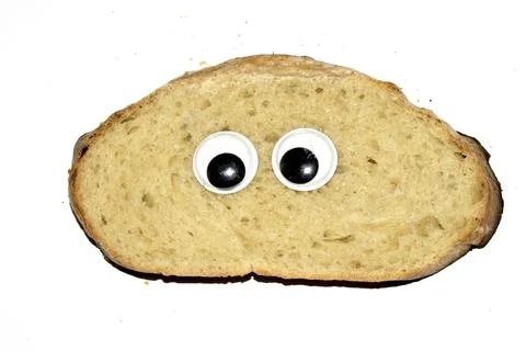 A Funny Burnt Toast Bread Slice Roll With Googly Wobble Eyes Stock Photos