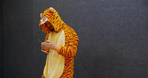 Funny business worker in open space wearing kigurumi, tiger pajama clothing Stock Footage 106077554