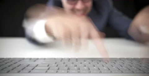 Funny businessman types fast on the computer keyboard, hard office work Stock Footage 136122269