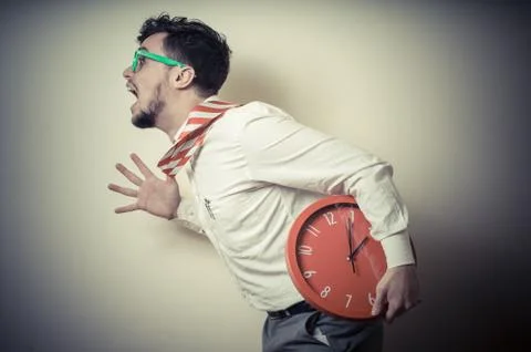 Funny businessman with wall clock Stock Photos