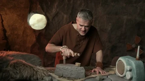 Funny caveman ironing clothes and listening to music 스톡 동영상 333048404